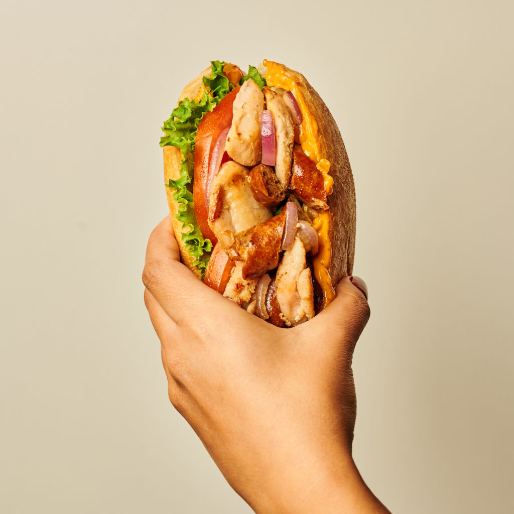 hand holding sandwich